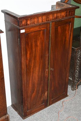 Lot 1280 - A Mahogany Wall Cabinet, 2nd quarter 19th century, with two panel doors enclosing an arrangement of