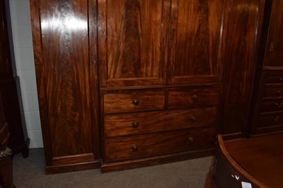 Lot 1283 - A 19th century mahogany triple wardrobe, 245cm by 65cm by 214cm