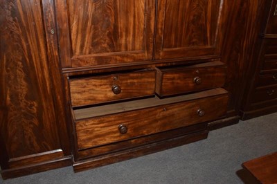 Lot 1283 - A 19th century mahogany triple wardrobe, 245cm by 65cm by 214cm