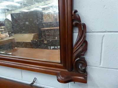Lot 1286 - A large mahogany arched top over-mantle mirror with bevelled mirror plate, shell and scroll...