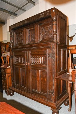 Lot 1294 - A 17th century oak court cupboard with foliate carved panel doors and turned supports, with...