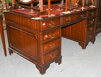 Lot 1295 - A reproduction mahogany twin pedestal desk with leather inset top, 150cm by 90cm by 80cm