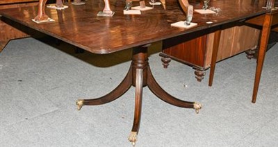 Lot 1299 - A Regency mahogany snap-top breakfast table raised on reeded sabre supports with brass claw...