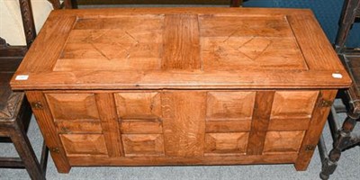Lot 1307 - A 20th century panelled oak coffer with brass mounts, 109cm by 49cm by 54cm