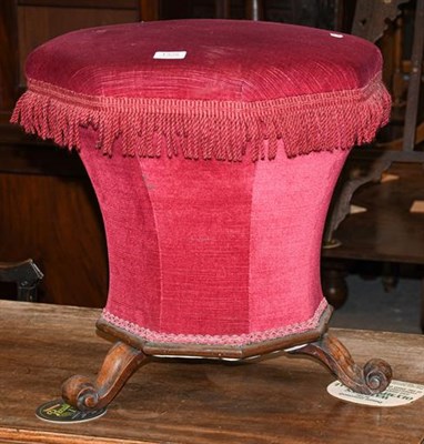 Lot 1308 - A Victorian rosewood octagonal workbox/stool with raspberry upholstery raised on three carved...