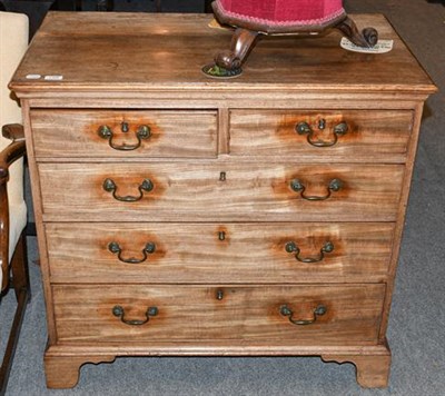 Lot 1309 - A George III mahogany four-height chest of drawers, with bronze drop handles, raised on brass feet