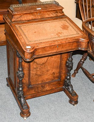Lot 1318 - A Victorian figured walnut Davenport with brass gallery leather-inset top and maple interior,...