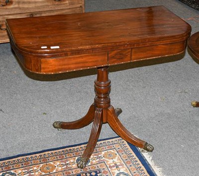 Lot 1319 - A 19th century mahogany fold-over tea table, on reeded scroll supports, 91cm by 45cm by 72cm