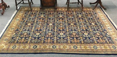 Lot 1320 - Indian rug of Perepdil design, the indigo field of rams horn motifs and flower heads enclosed...