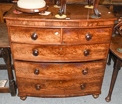 Lot 1342 - An early 19th century mahogany bow front four-height chest with turned handles and supports...