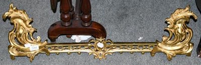 Lot 1349 - A late 19th century gilt-metal extendable fire fender, of foliate scroll and pierced design