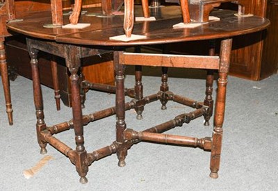 Lot 1360 - A 19th century oak gate-leg dining table, 145cm by 126cm open by 74cm