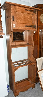 Lot 1375 - An Arts & Crafts light oak hall stand with top cupboard section having copper strap hinges, a...