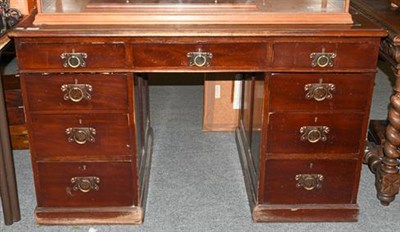 Lot 1383 - ~An early 20th century leather inset pedestal desk