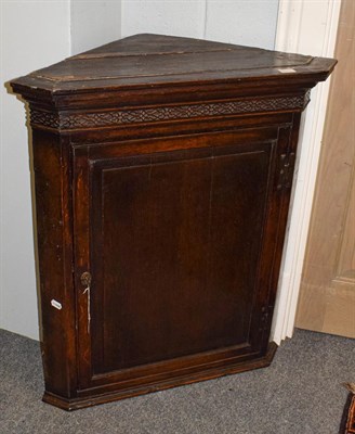 Lot 1389 - A George III oak corner hanging cupboard circa 1760