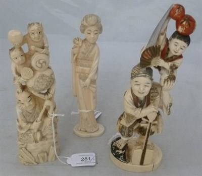 Lot 281 - A Japanese Ivory Okimono of a Musician, early 20th century, holding a young boy aloft, with...