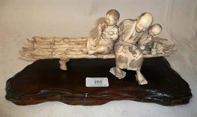 Lot 285 - A Japanese Ivory Okimono as a Man with Two Young Boys, Meiji Period (1868-1912), laughing and...
