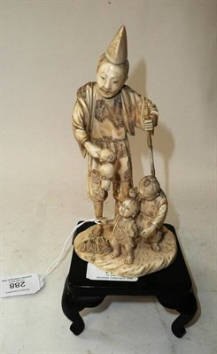 Lot 288 - A Japanese Carved Ivory Figure Group, Meiji period (1868-1912), as a man in a pointed hat...