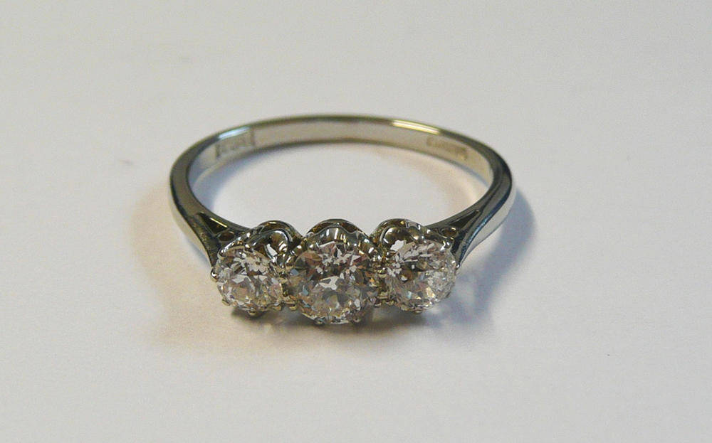 Lot 595 - A Diamond Three Stone Ring, the slightly graduated old cut diamonds in white claw settings, to...