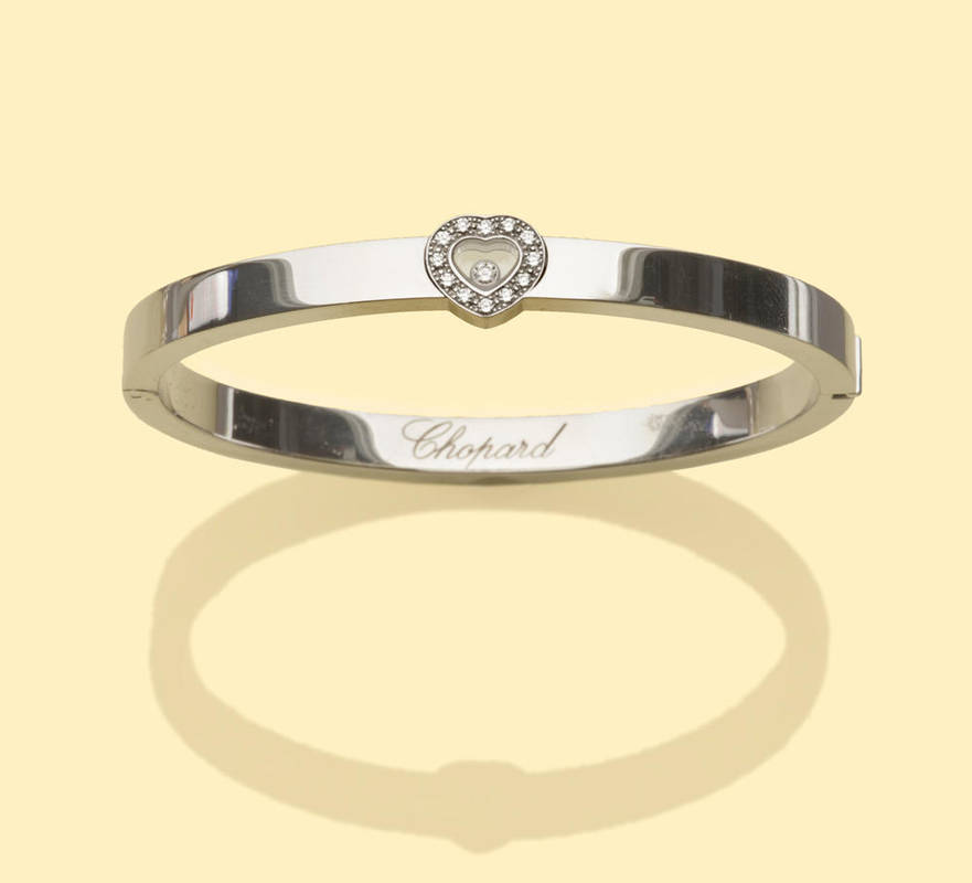 Lot 690 - An 18 Carat White Gold Bangle, by Chopard, a