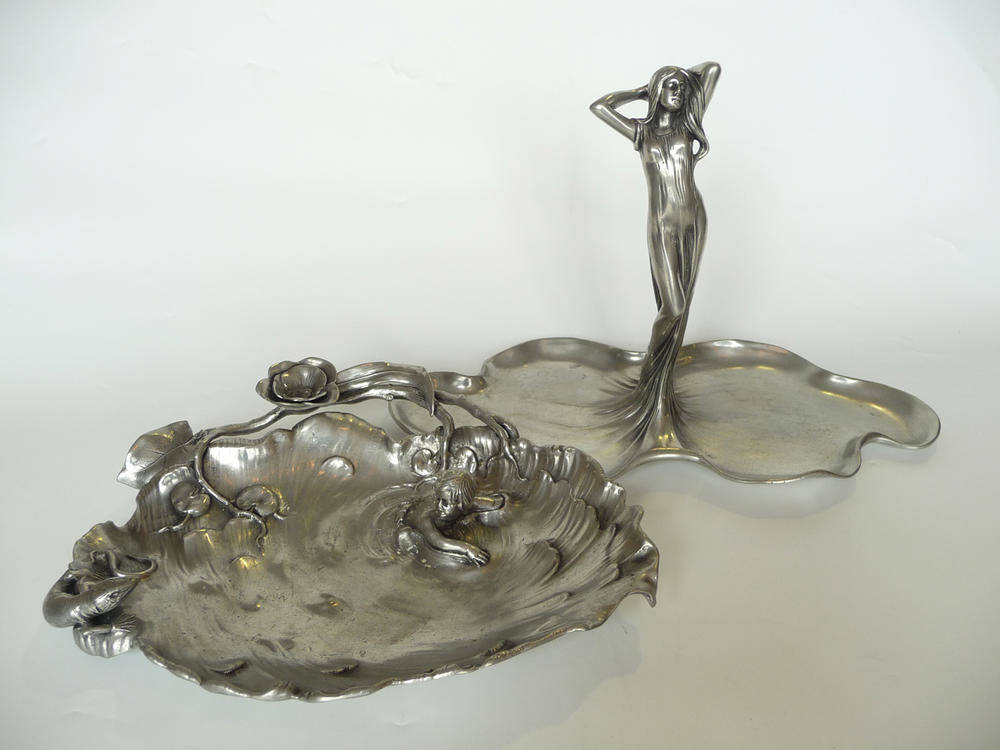 Lot 1505 - An Art Nouveau Italian Pewter Tray, cast as a child swimming away from a lizard, stamped...