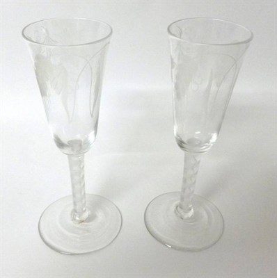 Lot 10 - A Pair of Ale Flutes, circa 1760, the rounded funnel bowls engraved with hops and barley on a...