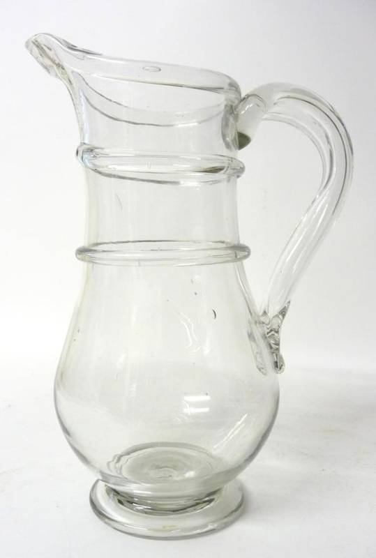 Lot 35 - A Glass Large Jug, 2nd half 18th century, of baluster form with two trailed bands to the neck...