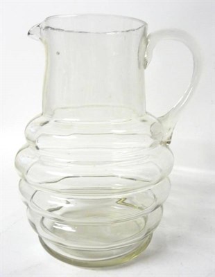Lot 38 - A Glass Water Jug, early 19th century, the ribbed oval body with cylindrical neck and loop...