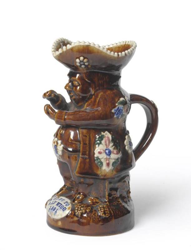 Lot 74 - A Measham Type Pottery Snuff-Taker Toby Jug, date 1891, typically applied and coloured with...