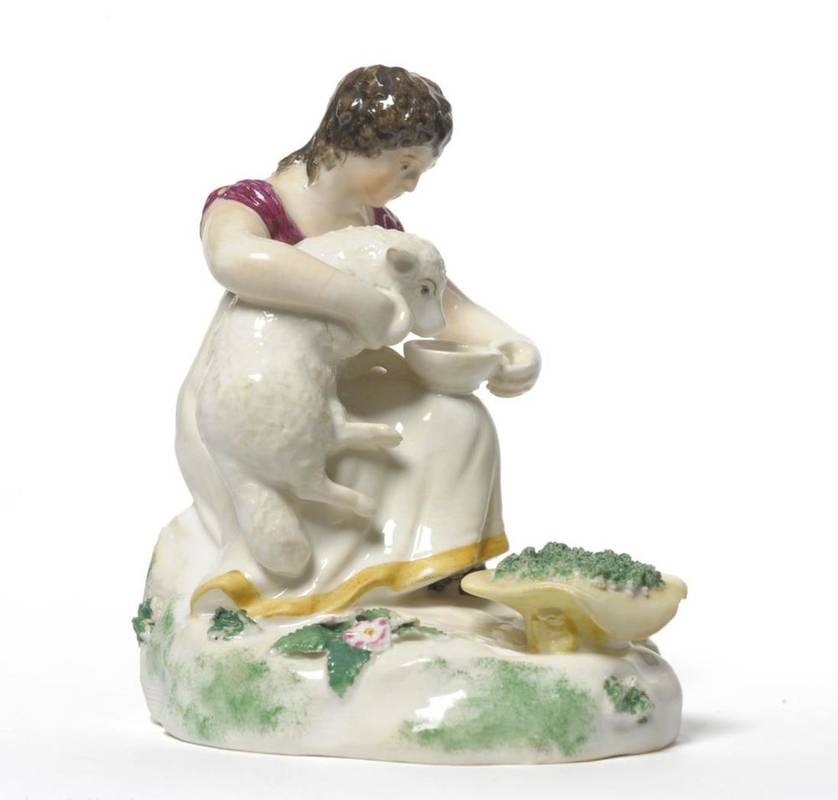 Lot 97 - A Rockingham Porcelain Figure of a Shepherdess, circa 1830, sitting holding a lamb under her...