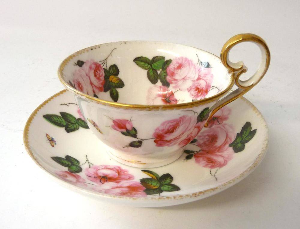 Lot 102 - A Nantgarw Porcelain Teacup and Saucer, circa 1820, with loop handle, painted in London with sprays