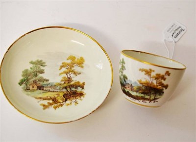 Lot 113 - A Pinxton Porcelain Bute Shaped Teacup and Saucer, circa 1800, painted with landscape vignettes...