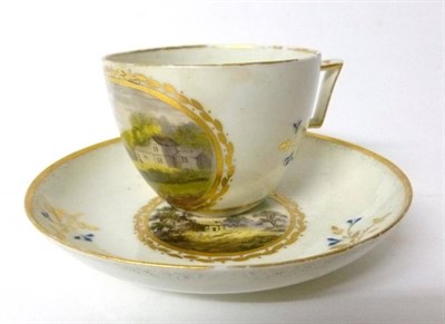 Lot 116 - A Pinxton Porcelain Teacup and Saucer, circa 1810, painted in colours with a view of Breadsall...