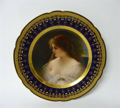 Lot 187 - A Vienna Porcelain Cabinet Plate, circa 1900, painted with a bust portrait of a maiden in a red...