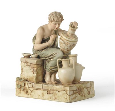 Lot 193 - A Royal Dux Porcelain Figure of a Potter, 20th century, the loosely draped figure sitting on a...