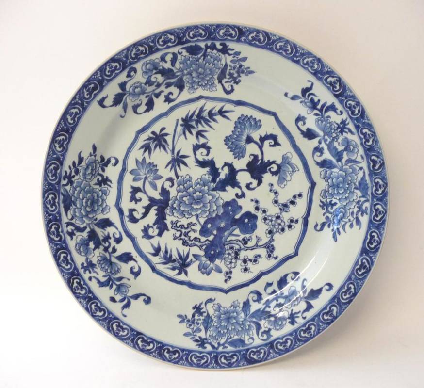 Lot 210 - A Chinese Porcelain Charger, mid 18th century, painted in underglaze blue with bamboo, peony...