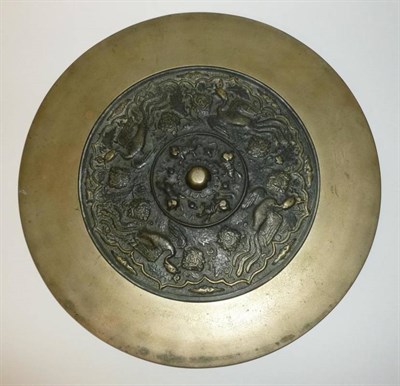 Lot 269 - A Chinese Bronze Large Mirror, probably Ming in Tang style, the central circular boss within a...