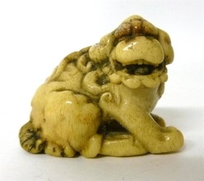 Lot 292 - A Japanese Stag Antler Netsuke, 19th century, modelled as a seated shi-shi, unsigned, 3.5cm long