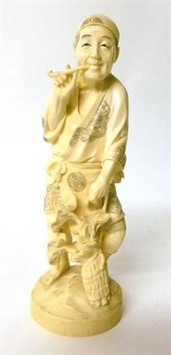 Lot 295 - A Japanese Ivory Okimono of a Man, early 20th century, standing wearing traditional dress smoking a