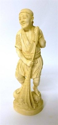 Lot 298 - A Japanese Ivory Okimono as a Fisherman, early 20th century, standing in traditional garb pulling a