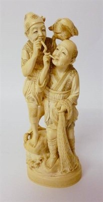 Lot 300 - A Japanese Ivory Okimono, Meiji period, as two figures standing on a rock, the fisherman...