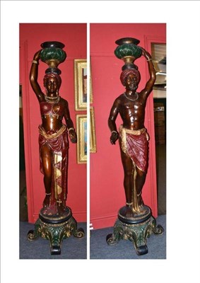 Lot 331 - A Pair of Polychrome Cast Figures of Nubians, as a young man and woman scantily clad wearing...