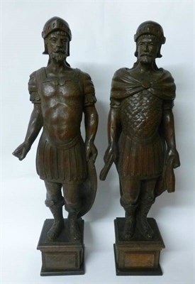 Lot 332 - A Pair of German Carved Oak Figures, in Renaissance style, as Roman soldiers wearing helmets...