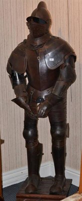 Lot 359 - A Suit of Armour, in 15th century style, the crested helmet with pierced visor, on a wooden plinth