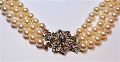 Lot 475 - A Cultured Pearl Necklace, three rows of 48:51:55 knotted uniform pearls strung to a diamond...