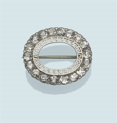 Lot 479 - A Diamond Hoop Brooch, the oval frame, with an open centre, to a white fine Greek key design...