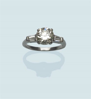 Lot 488 - A Diamond Solitaire Ring, the round brilliant cut diamond in a white four claw setting, with a...