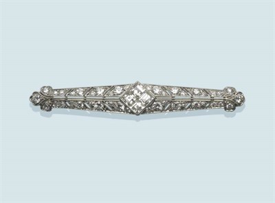 Lot 491 - A Diamond Brooch, of bar form, with four step cut diamonds centrally and old cut and single cut...