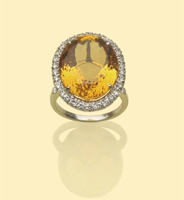 Lot 498 - An 18 Carat White Gold Citrine and Diamond Cluster Ring, the oval cut citrine within a border...