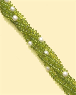 Lot 500 - A Peridot and South Sea Pearl Torsade, of multiple strands of faceted peridot beads, strung...